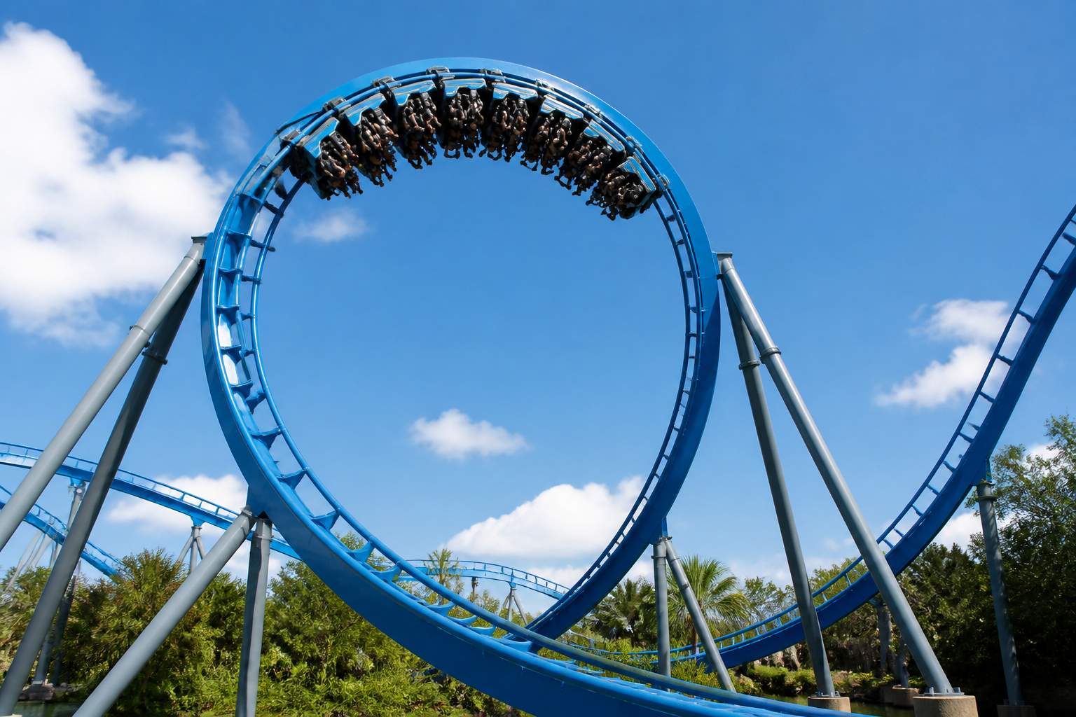 Modern roller coaster loop in Orlando theme park under blue sky